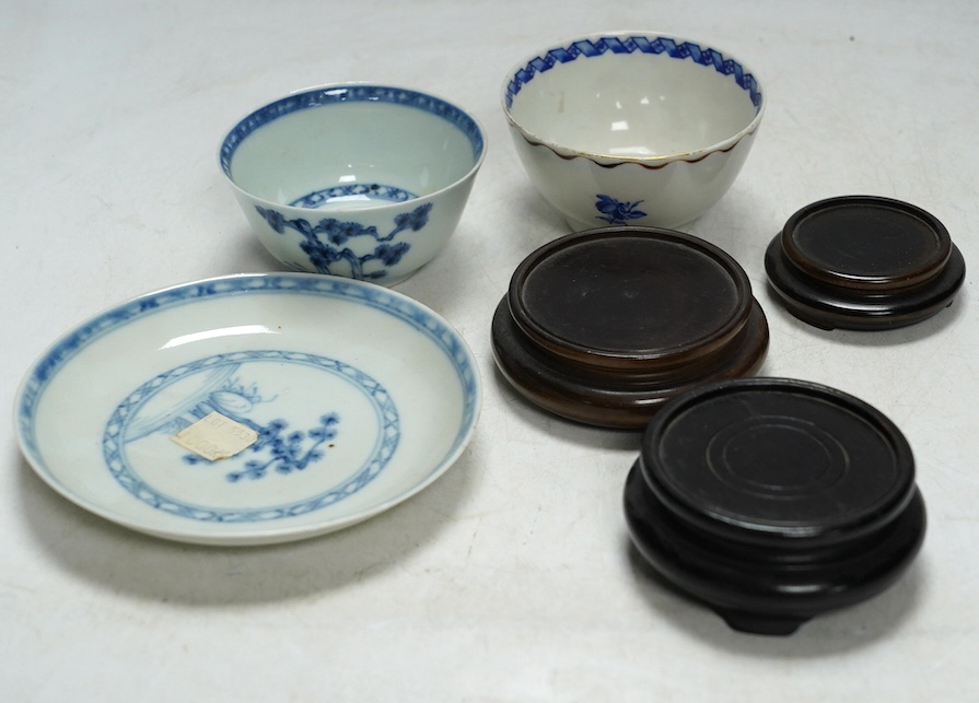 A Chinese Tek Sing Cargo tea bowl and saucer, a Nanking Cargo saucer, two other tea bowls and six small hardwood stands. Condition - fair